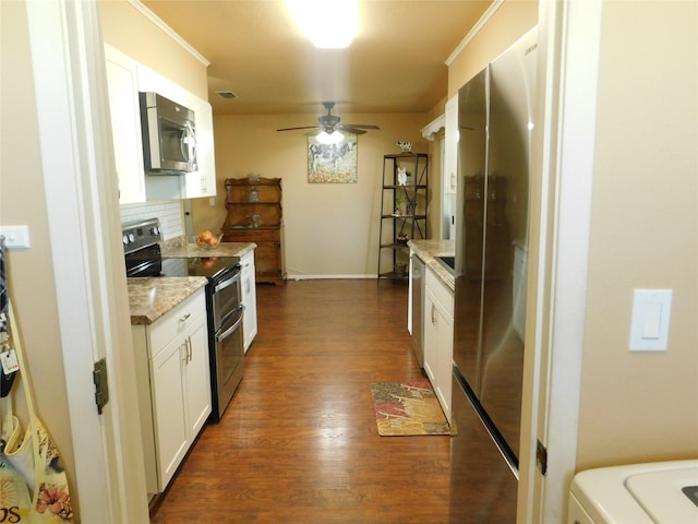 kitchen with dark wood-style floors, appliances with stainless steel finishes, ornamental molding, and decorative backsplash