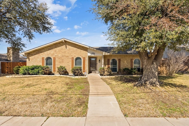 single story home with brick siding, a front lawn, and fence