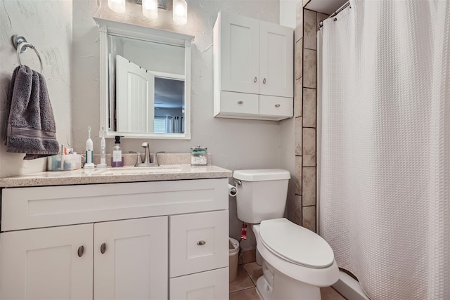 full bath featuring tile patterned flooring, a shower with curtain, vanity, and toilet