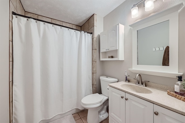 full bathroom with toilet, curtained shower, tile patterned flooring, a textured ceiling, and vanity