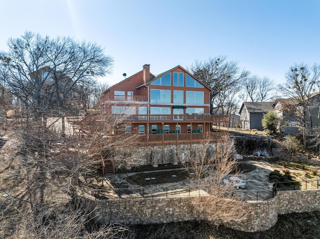 back of property featuring a deck and a chimney