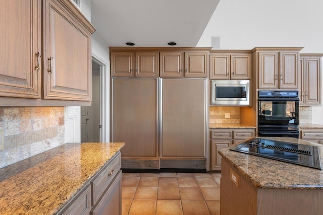 kitchen featuring light tile patterned floors, black appliances, light stone counters, and decorative backsplash