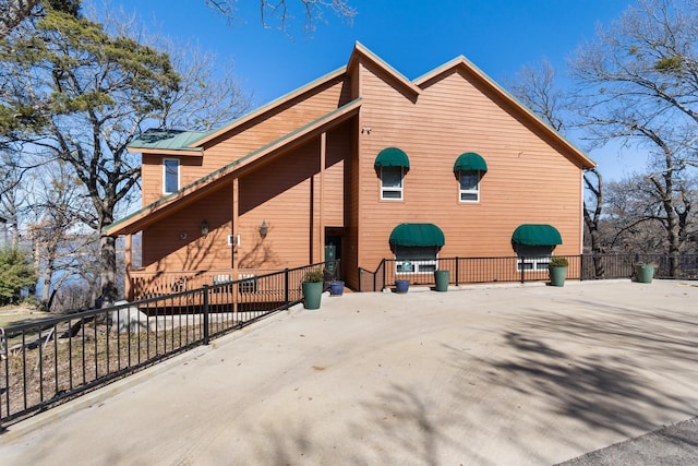 view of home's exterior with fence