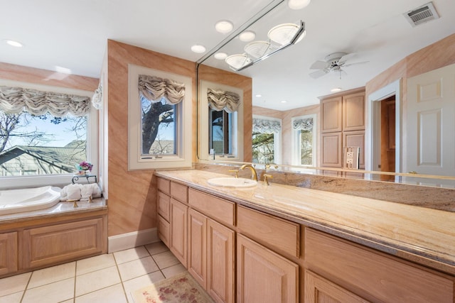 bathroom with a garden tub, visible vents, ceiling fan, vanity, and tile patterned floors