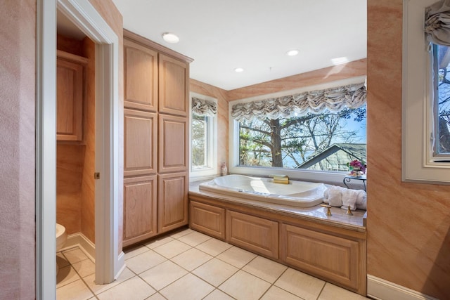 bathroom with recessed lighting, a washtub, and tile patterned floors