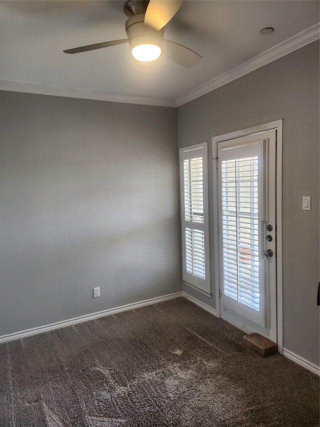 spare room with baseboards, carpet, a ceiling fan, and crown molding