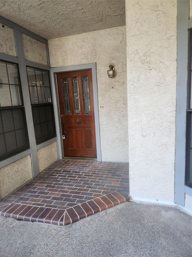 doorway to property with stucco siding