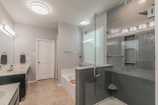 bathroom with a stall shower, tile patterned floors, vanity, and a bath