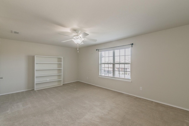 unfurnished room featuring light carpet, ceiling fan, visible vents, and baseboards