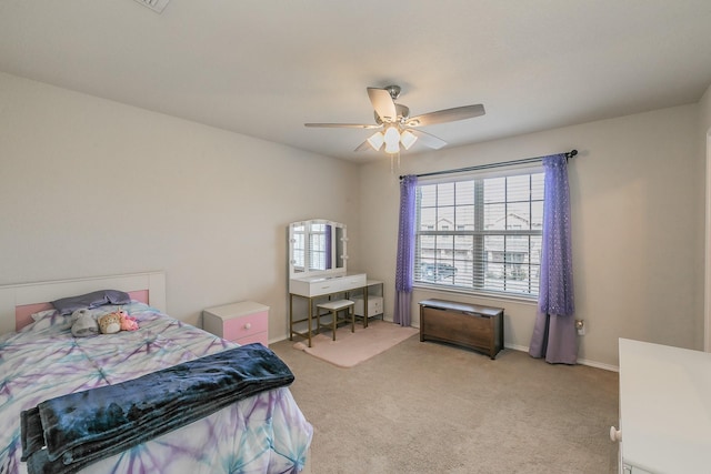 bedroom with baseboards, a ceiling fan, and light colored carpet