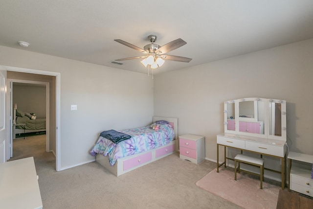 carpeted bedroom with visible vents, ceiling fan, and baseboards