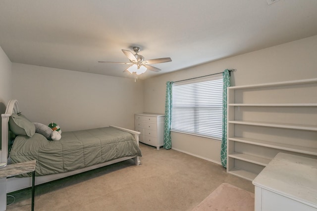 bedroom with light carpet, ceiling fan, and baseboards