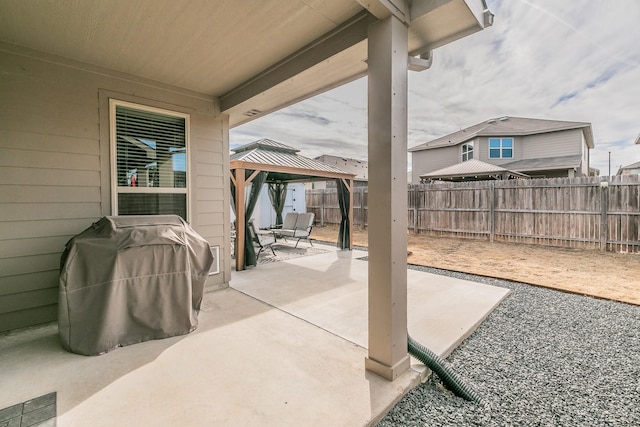 view of patio / terrace featuring a fenced backyard, grilling area, and a gazebo