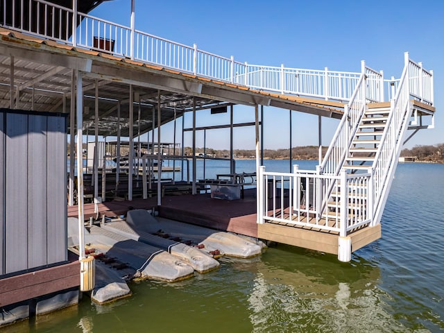 view of dock with stairway and a water view