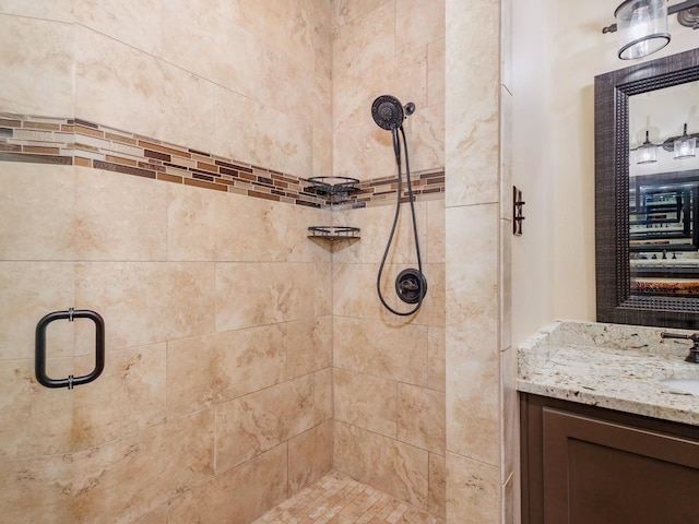 full bathroom featuring a stall shower and vanity