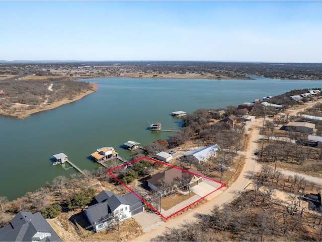 birds eye view of property with a water view