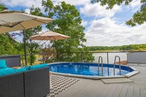 pool featuring a deck with water view