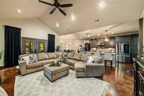 living area with ceiling fan, high vaulted ceiling, visible vents, and recessed lighting