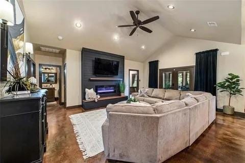 living area featuring recessed lighting, ceiling fan, high vaulted ceiling, and a glass covered fireplace