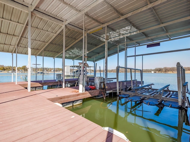 dock area with a water view and boat lift