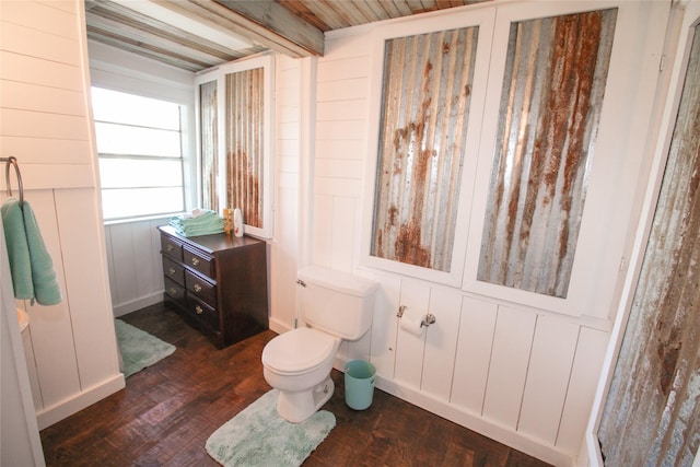 bathroom with toilet and wood finished floors