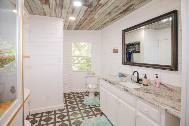 bathroom featuring tile patterned floors, toilet, recessed lighting, wood ceiling, and vanity