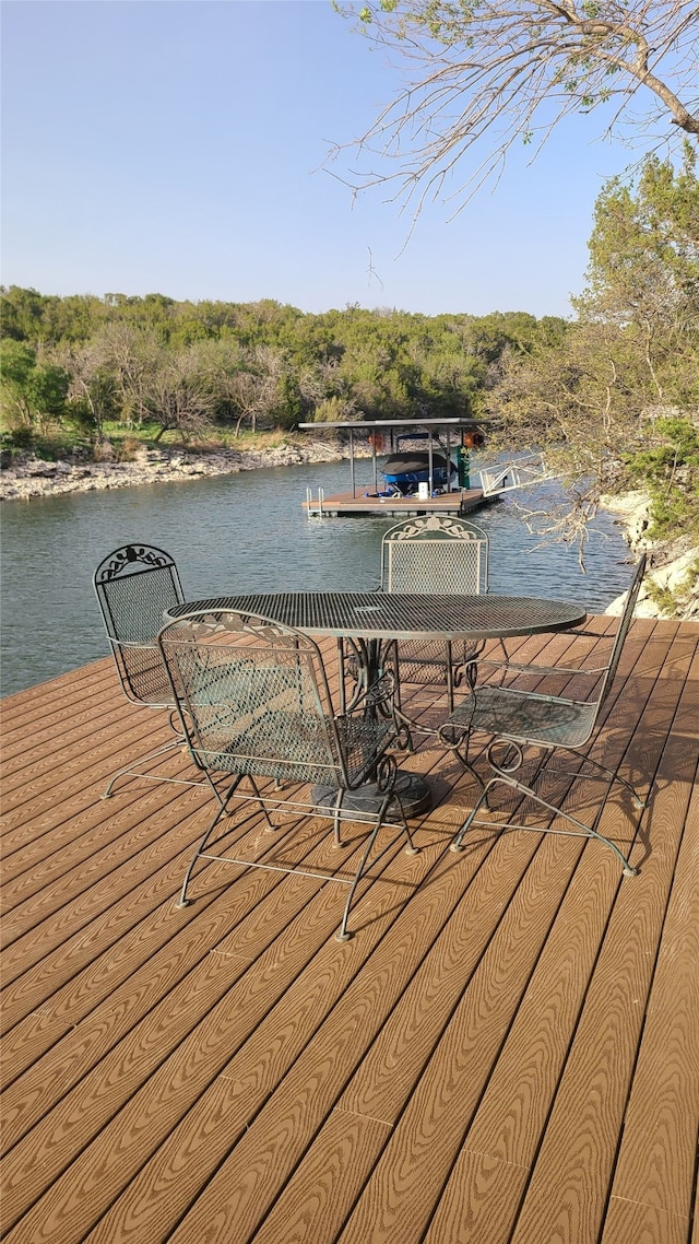 view of dock with a view of trees and a water view