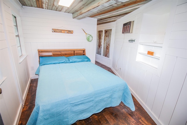 bedroom featuring beam ceiling, wooden ceiling, a wall mounted AC, and wood finished floors