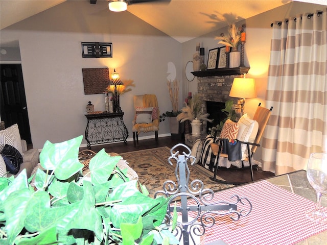 interior space with lofted ceiling and a stone fireplace