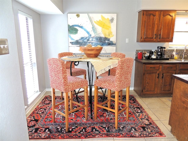 dining area featuring baseboards and light tile patterned floors