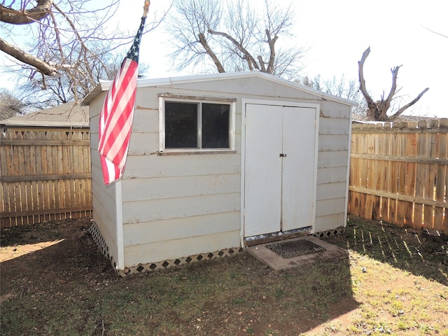 view of shed with a fenced backyard