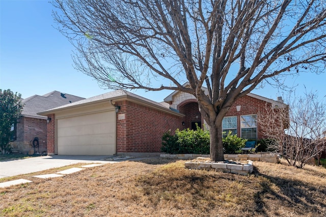 ranch-style home with concrete driveway, brick siding, and an attached garage