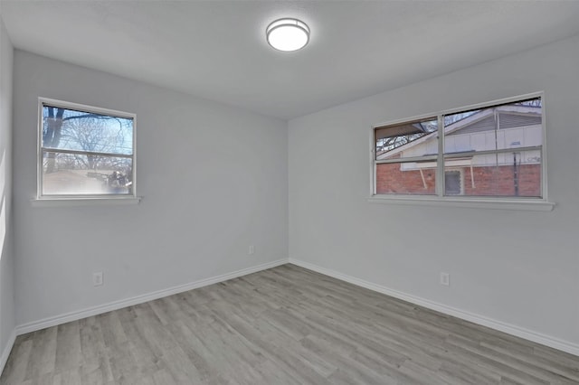 empty room featuring baseboards and wood finished floors