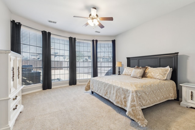 bedroom with visible vents, carpet floors, and ceiling fan