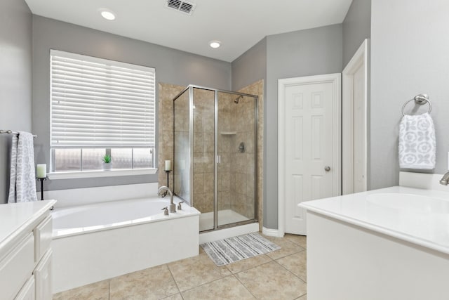 bathroom with tile patterned flooring, vanity, visible vents, and a stall shower