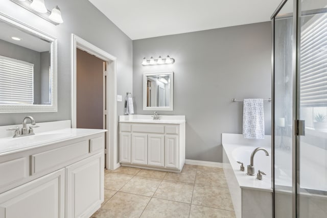 bathroom with two vanities, a sink, tile patterned flooring, a shower stall, and a garden tub