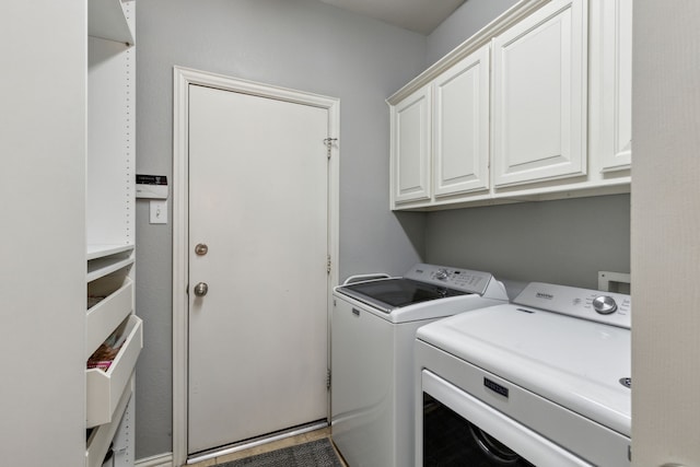 laundry area with cabinet space and separate washer and dryer