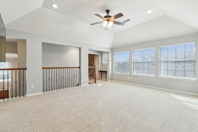 unfurnished room featuring lofted ceiling, visible vents, a wealth of natural light, and ceiling fan