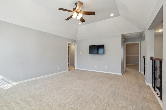 empty room featuring visible vents, lofted ceiling, baseboards, light colored carpet, and ceiling fan