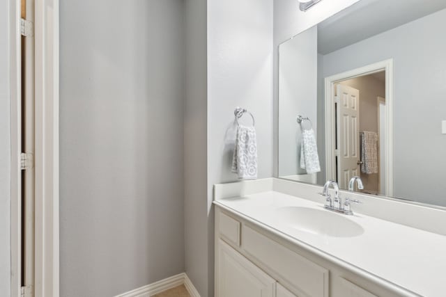 bathroom featuring baseboards and vanity