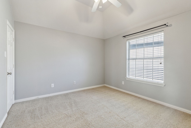 carpeted spare room with baseboards, lofted ceiling, and ceiling fan