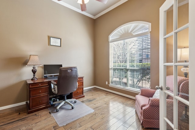 office area featuring ceiling fan, light wood-type flooring, baseboards, and ornamental molding