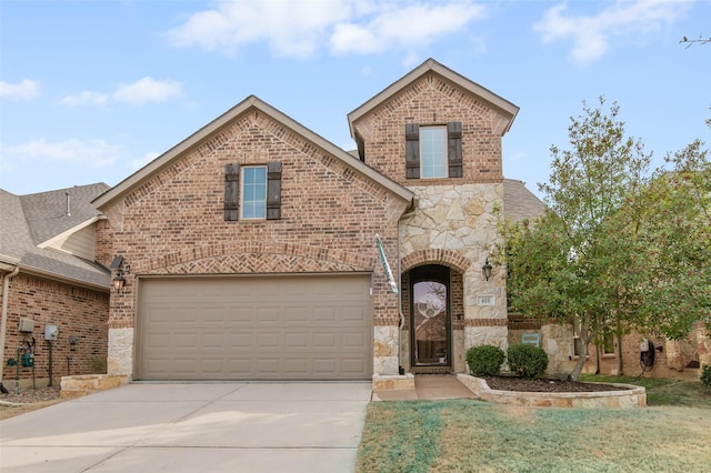 view of front of property featuring stone siding, concrete driveway, and brick siding