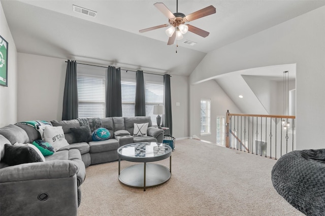 living area featuring ceiling fan, visible vents, vaulted ceiling, and carpet flooring