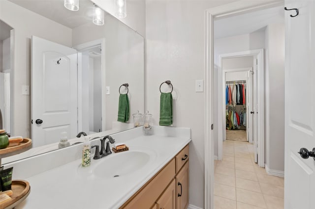 bathroom with tile patterned flooring, baseboards, and vanity