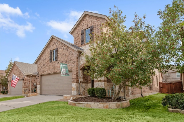 traditional-style home featuring brick siding, concrete driveway, an attached garage, a front yard, and stone siding