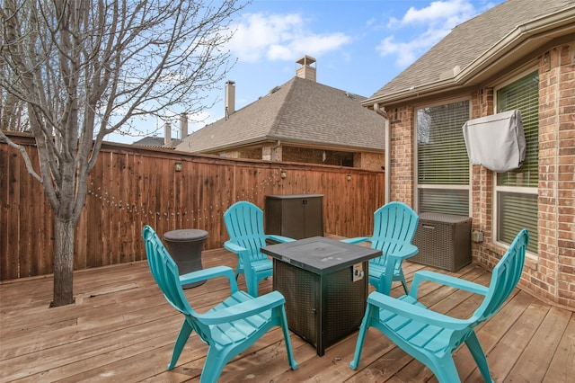 wooden terrace featuring fence