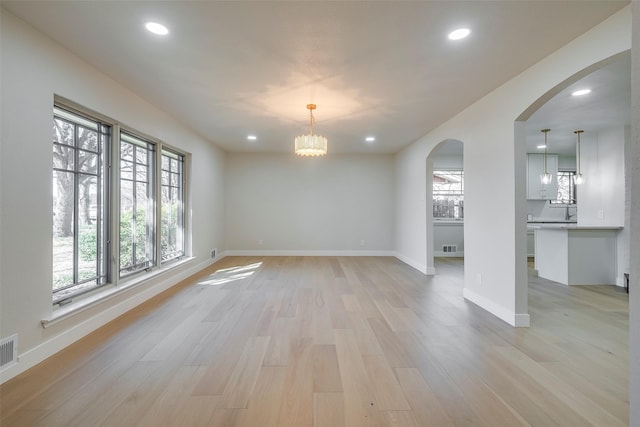 unfurnished room featuring baseboards, light wood finished floors, and recessed lighting