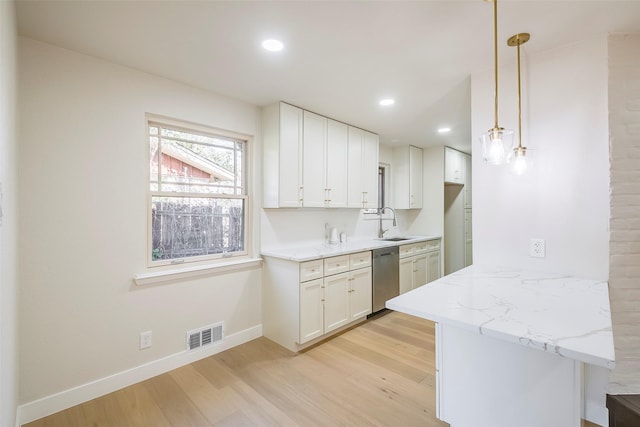 kitchen featuring light wood-type flooring, visible vents, a sink, and stainless steel dishwasher