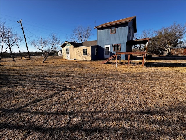 back of property featuring stairway